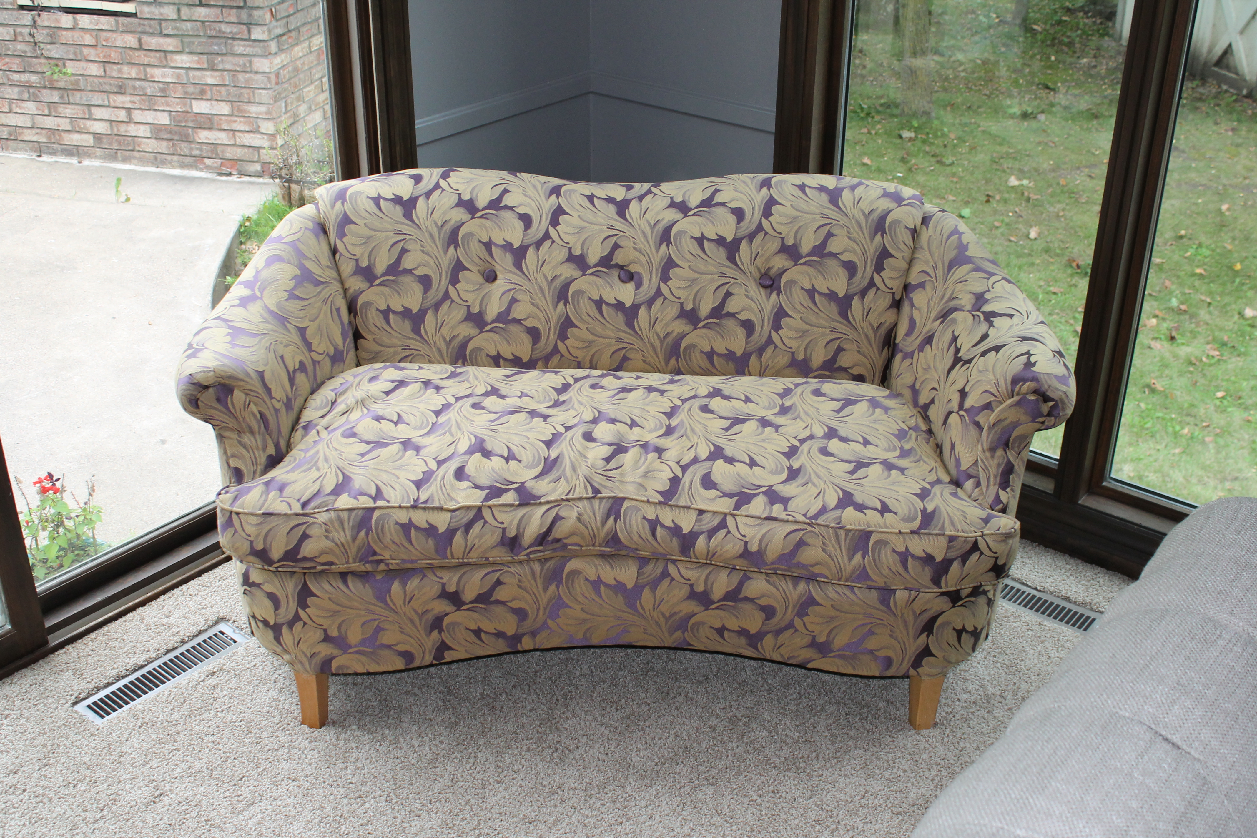 purple and gold reupholstered tufted vintage couch