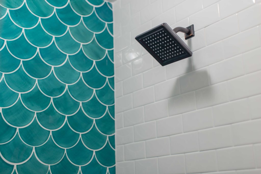 moroccan fish tile in white shower | 5 Plumbing Considerations When Renovating Your Bathroom | construction2style
