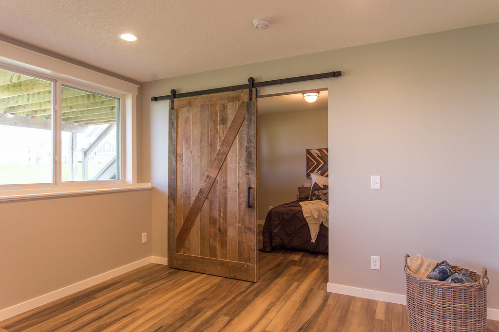 reclaimed wood barn door in basement | construction2style