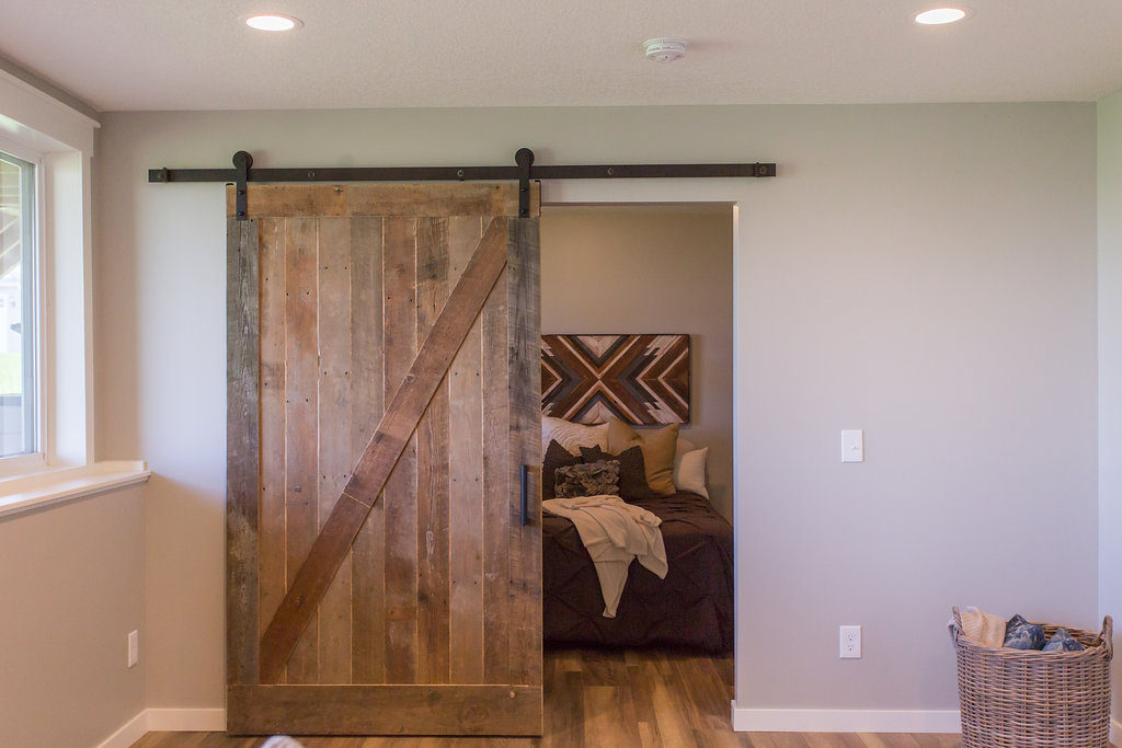 guest room reclaimed barn door in modern farmhouse basement | construction2style