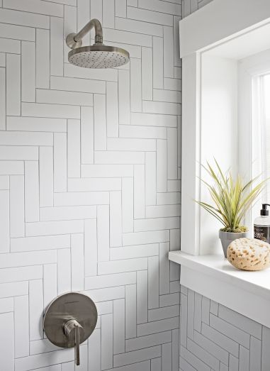 Herringbone at 45 degrees White subway tile pattern in a shower | construction2style