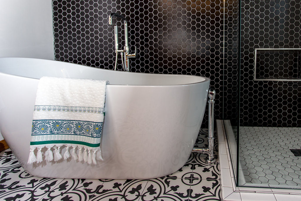 Black hexagon tile wall, Modern Design with a Wet Room Feel | Modern White free standing tub | construction2style