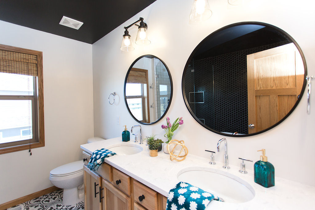 Black and white modern bathroom | black round mirrors | black ceilings | wood vanity | construction2style
