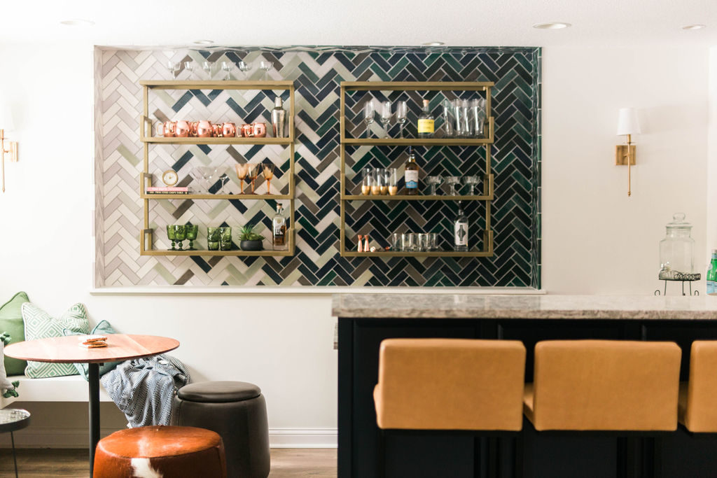 wet bar and dry bar are the future of interior design and this photo of a dry bar with chairs in jewel tones and bold backsplash are a great example of 2025 interior design trends