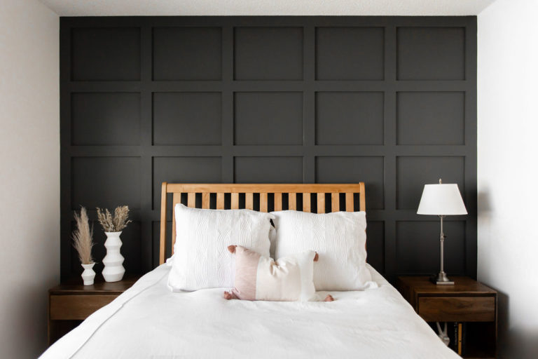 Black board and batten accent wall against a white aesthetic bedroom.