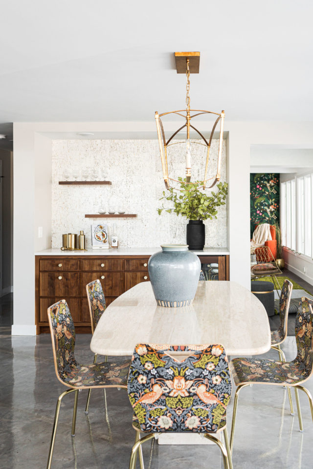 a photo of an open floor space in a custom home in Minnesota | featuring six Morris & Co's anthropologie dining chairs, bold light fixture and a dry custom bar a true future of interior design