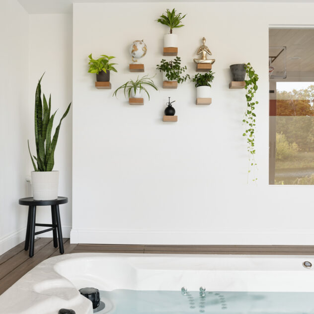 shelfology floating shelves in a room with a hot tub in a custom home designed by construction2style