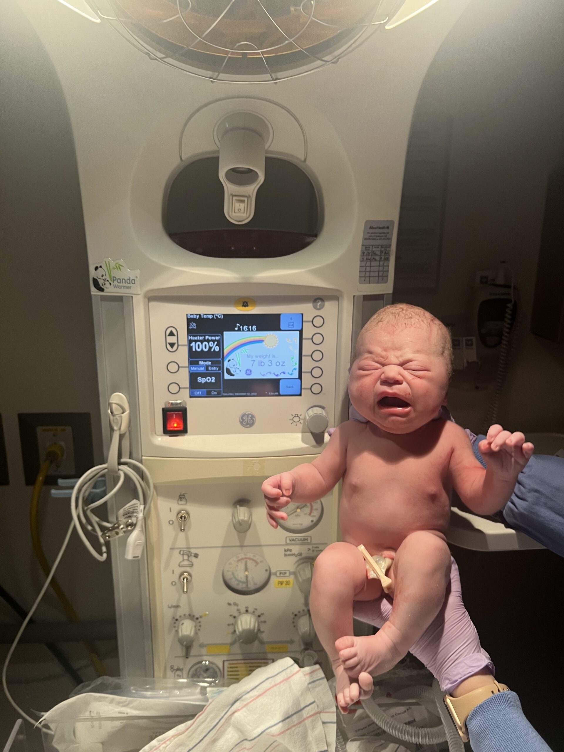 Solange minutes after being delivered under the heat lamps, she's crying and confused and the nurse at Mother Baby center is holding her up to the machine that says her birth weight, 7 lbs 3 oz.