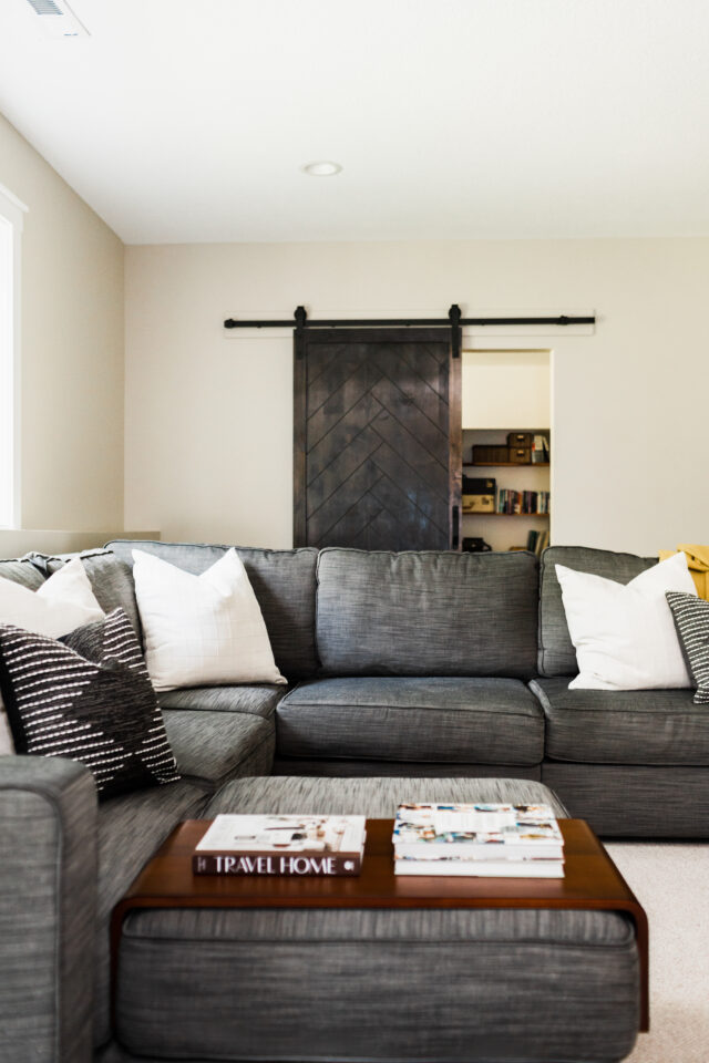 different textures and colors of pillows on a sofa in the basement