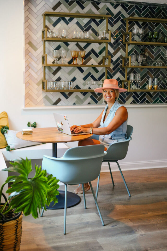 a photo of Morgan Molitor working in her basement near the dry bar area with a beautiful bold color tile wall | construction2style