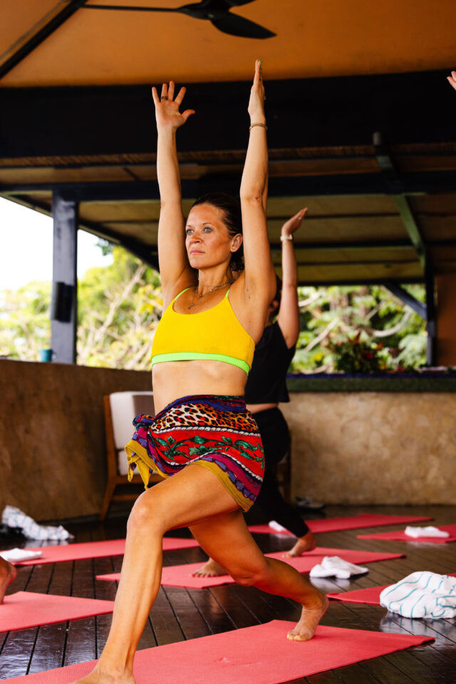 Morgan Molitor taking a yoga class in Costa Rica, wearing a two-piece high waisted mom bathing suit