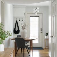 scandinavian minimalism | hallway with 1950s Scandinavian Modern Finn Juhl inspired table and chairs