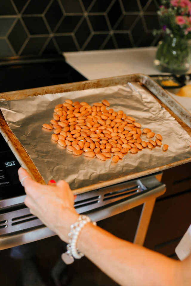 putting whole almonds on a cooking sheet to roast for 5 minutes to add to Cantucci batter