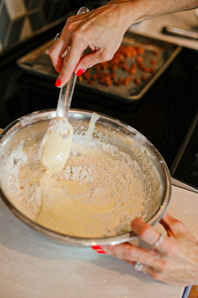 gently folding Cantucci dough with spatula