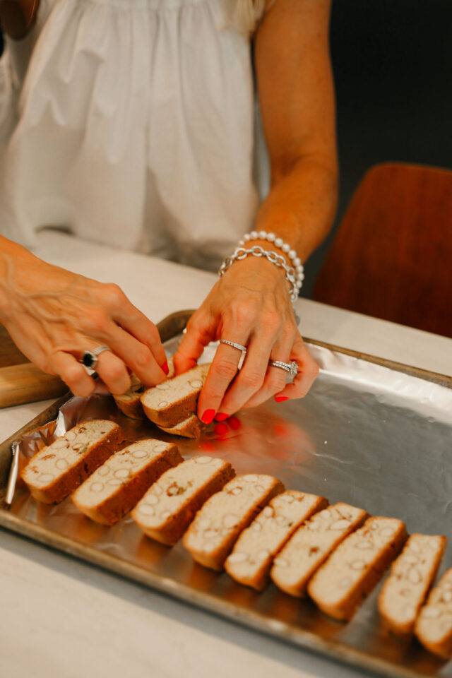 placing almond biscotti back on the baking sheet to bake the second time 