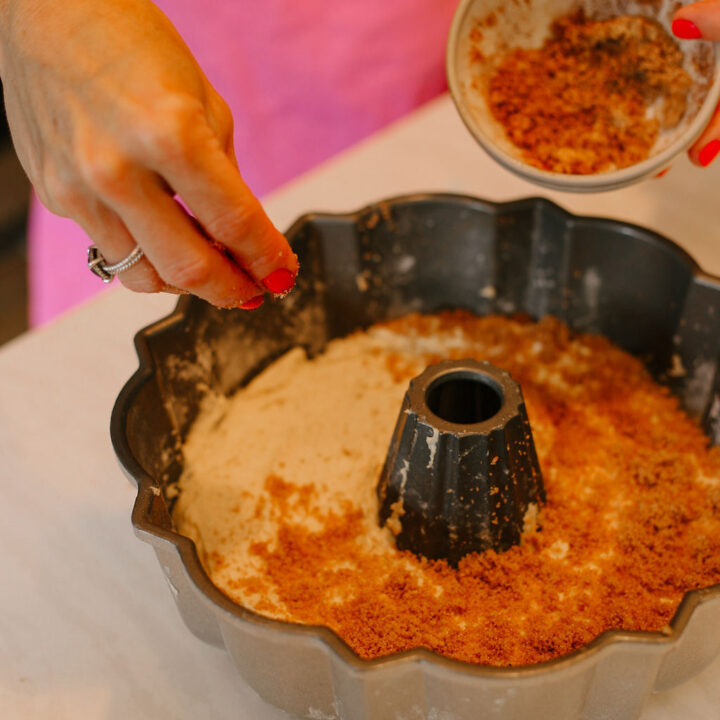 cinnamon brown sugar mixture is being placed on top of the cake batter