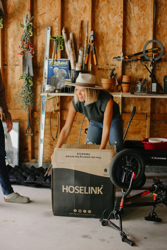 the owner of construction2style in the garage unpacking floating shelves 