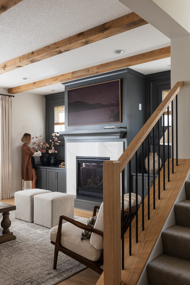 example of perfectly placed recessed lights in between box beams in the great room in a custom home in Minnesota