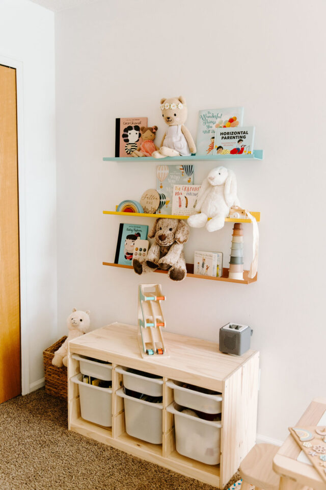 books and toys displayed on nursery shelves in toddler room with a toniebox on top of the ikea storage unit