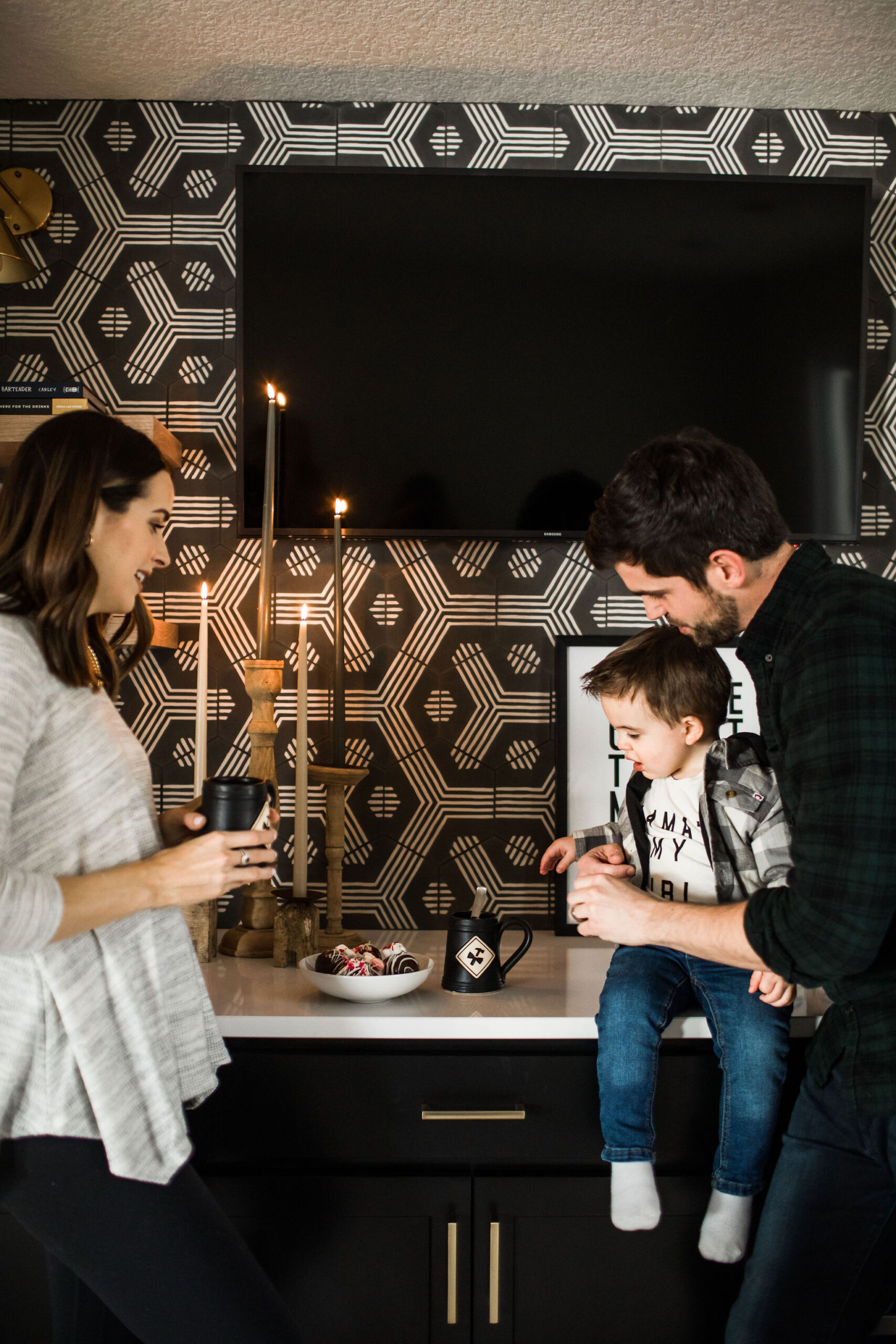 a photo of a mom and dad and a toddler making chocolate bombs - recipe valentines day