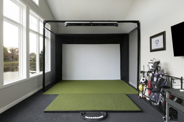 an indoor golf simulator is a wellness space in a custom home designed and built by construction2style crew | 2025 interior design trends