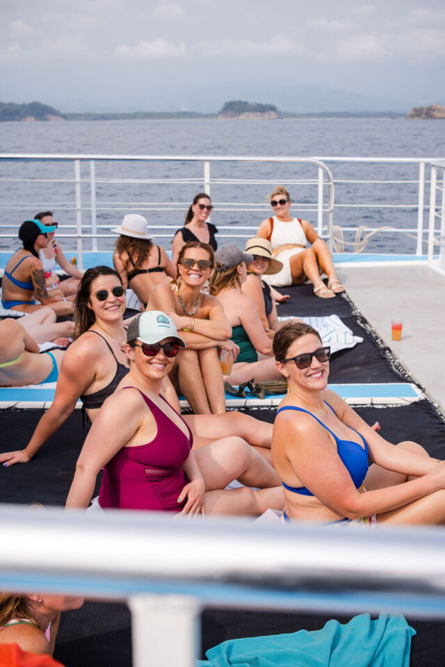 a photo of the attendees of buildher retreat sitting on the sundeck of the boat 