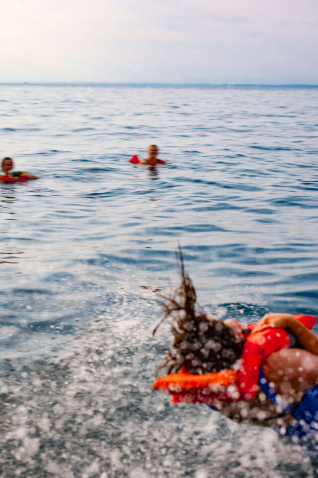 female contractors diving into the ocean in costa rica | buildher retreat 2025 