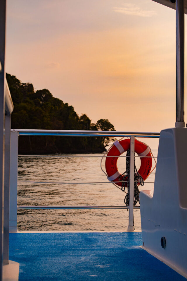 a beautiful shot of the mountain and the ocean from a yacht in costa rica at sunset 