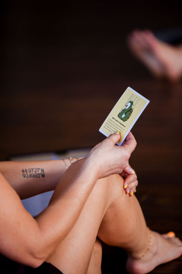 a woman holding an intention card after a yoga session 