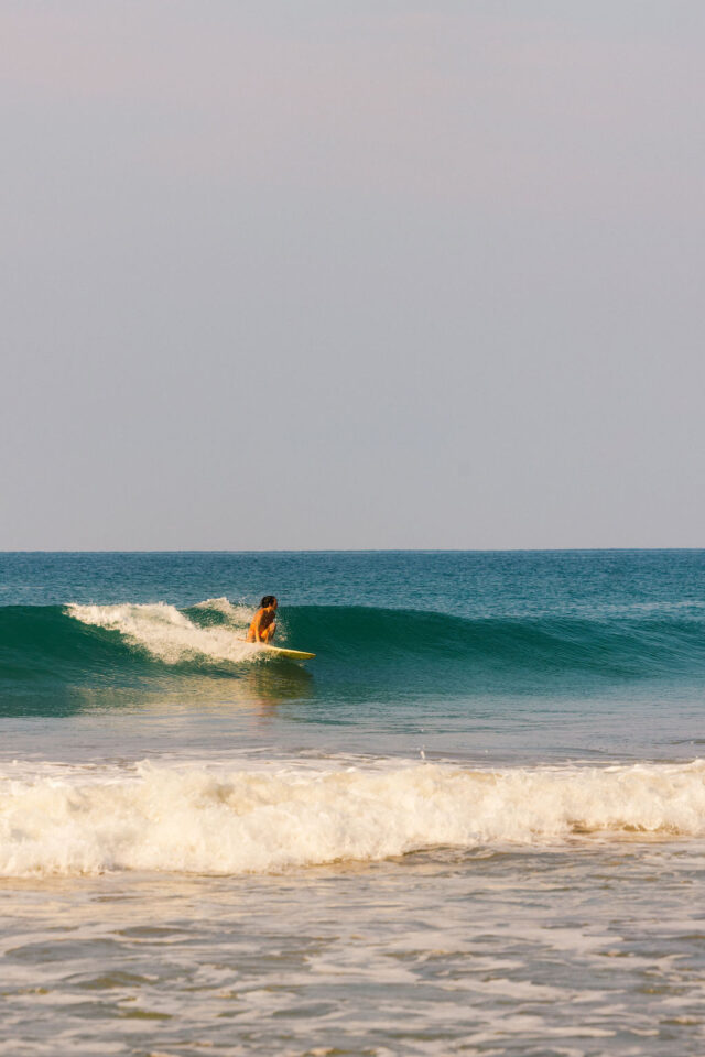 a photo of a woman surfing in costa rica