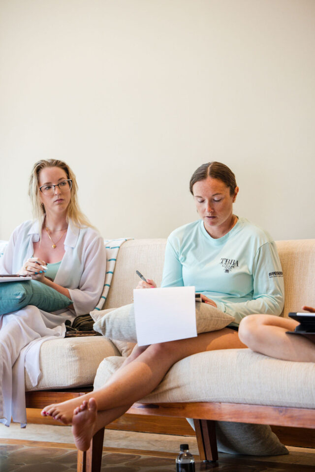 a photo of Marcie Cromwell founder of Fern & Vine Design with her colleague taking notes during the presentation at contractor conference for women in costa rica 2025 
