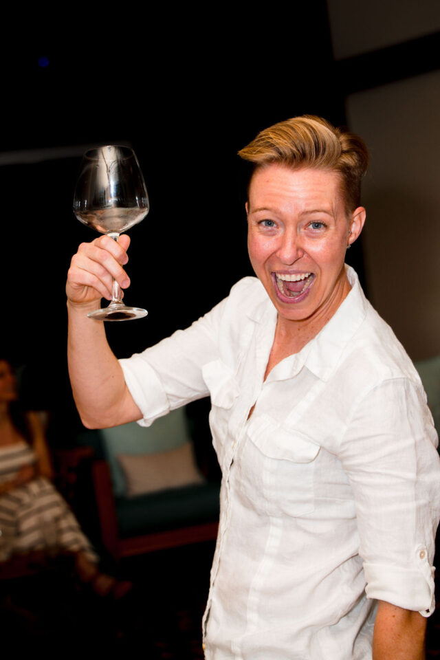 a photo of Kali Sudbrook, holding a wine glass, she is the owner and operator of Beachside Interiors in So Cal who is a licensed B-2 remodeling contractor and interior designer