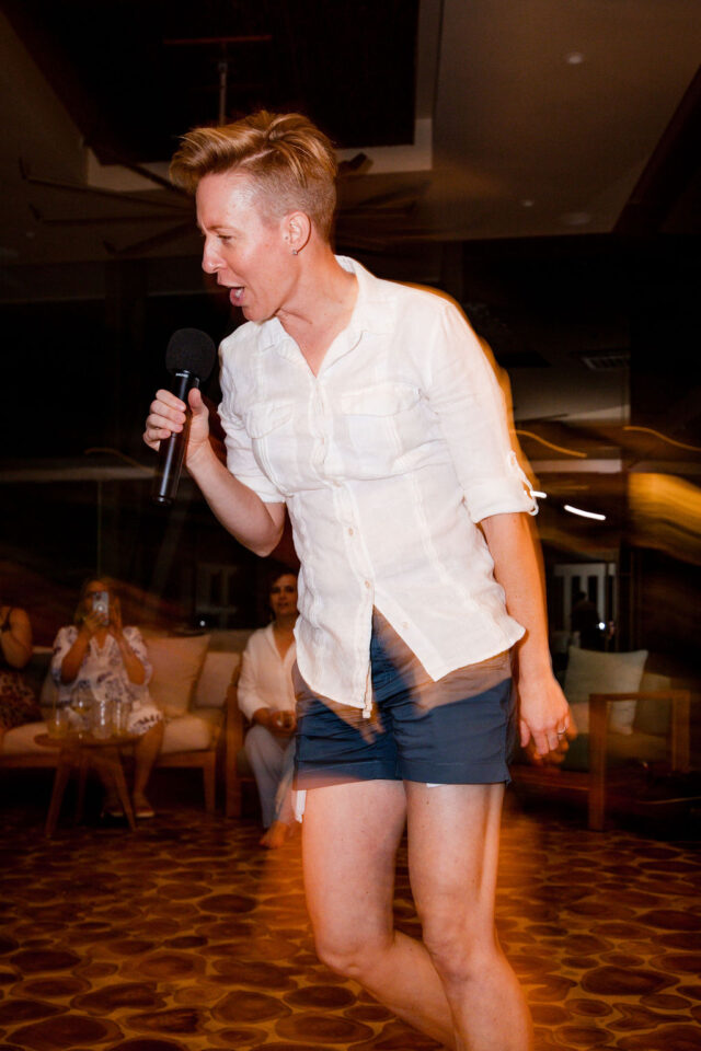 a female contractor, singing karaoke after dinner at contractor conference for women, called buildher 2025 held in costa rica