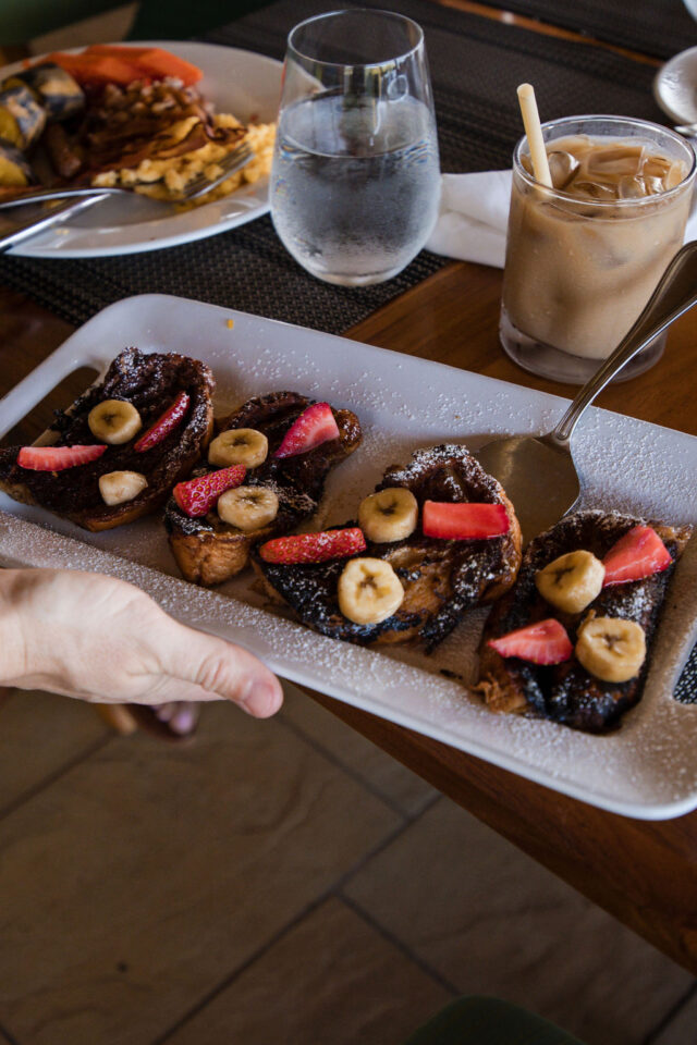 a plate with french toasts, bananas, strawberries and chocolate on a rectangular plate | costa rica buildher retreat 2025 