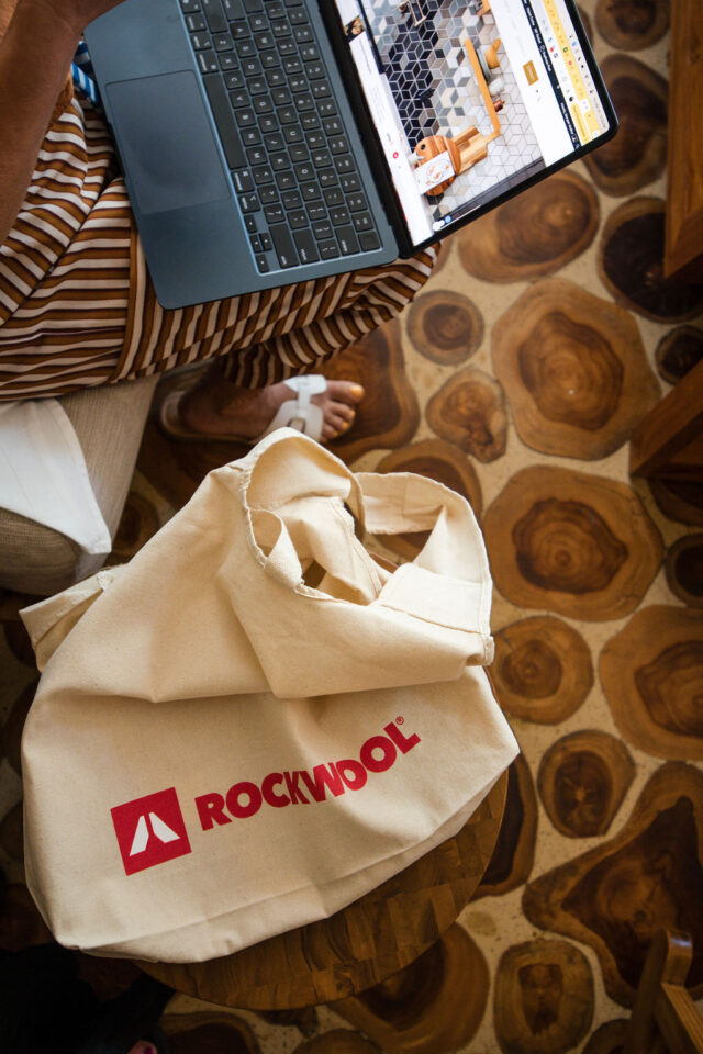 a laptop open to construction2style website with a rockwool branded linen bag 