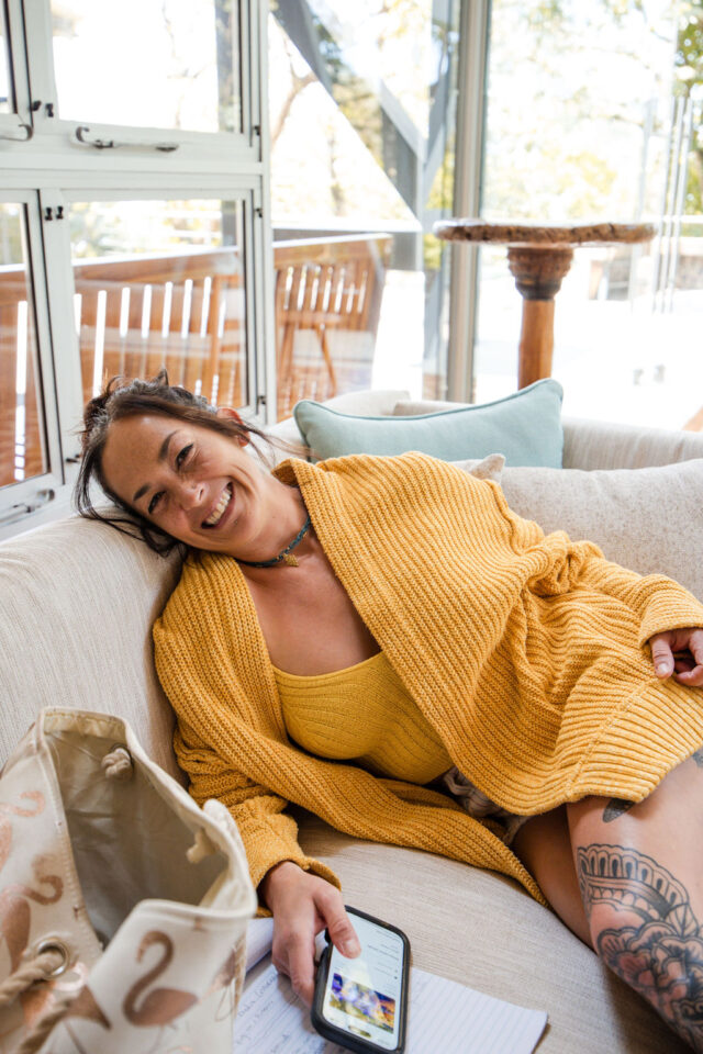 a female contractor sitting on the couch at a villa in costa rica during contractor conference for women 
