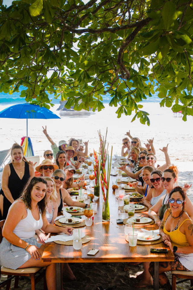 A photo of a group of female contractors having lunch on the beach while attending a female contractor retreat in Costa Rica in March of 2025, organized by Morgan Molitor from construction2style, Meghan Billings from Meg & Co, and Allyson Case Anderson from Integro Builders
