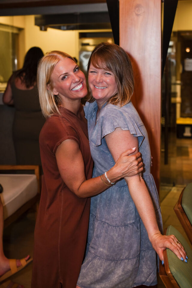 A photo of two female contractors laughing after dinner, attending a female contractor retreat in Costa Rica in March of 2025, organized by Morgan Molitor from construction2style, Meghan Billings from Meg & Co, and Allyson Case Anderson from Integro Builders