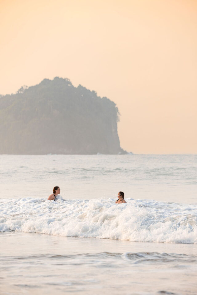 two female contractors swimming in the ocean in costa rica while attending a contractor conference for women called buildher retreat 2025