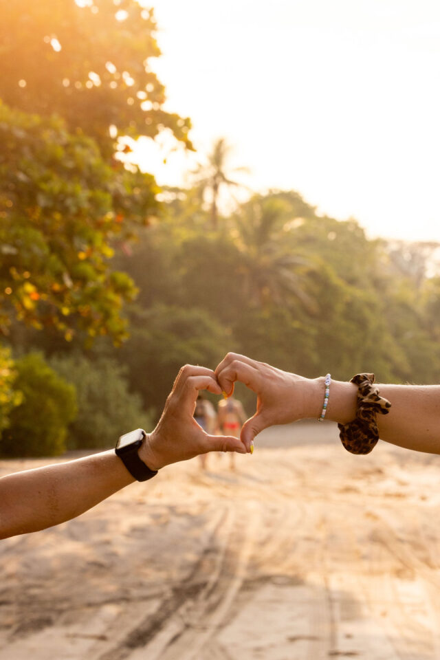 two hands forming a heart on the beach in costa rica at buildher retreat 2025