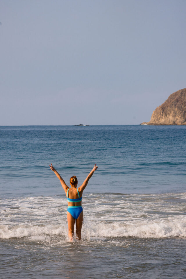 A photo of Morgan Molitor, a female contractor of construction2style entering the ocean while at buildher retreat in Costa Rica in March of 2025