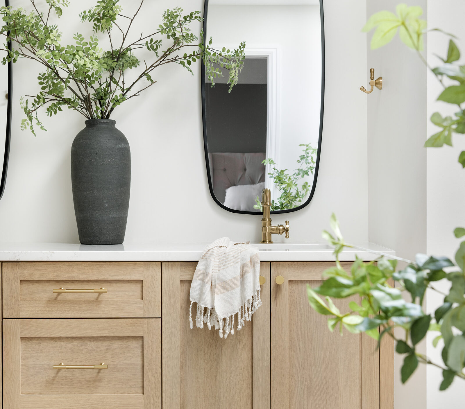 a photo of a beautiful double vanity with gold hardware designed by construction2style