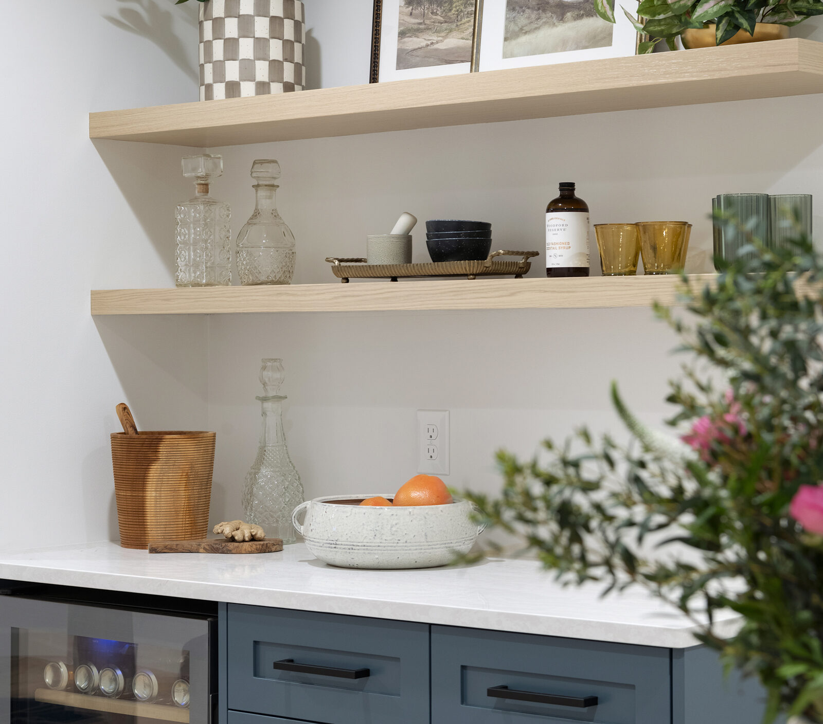 a photo of a drybar in the lower lower, designed by construction2style small fridge, base cabinetry, drawers with rift white oak shelves by Sean's Cabinetry