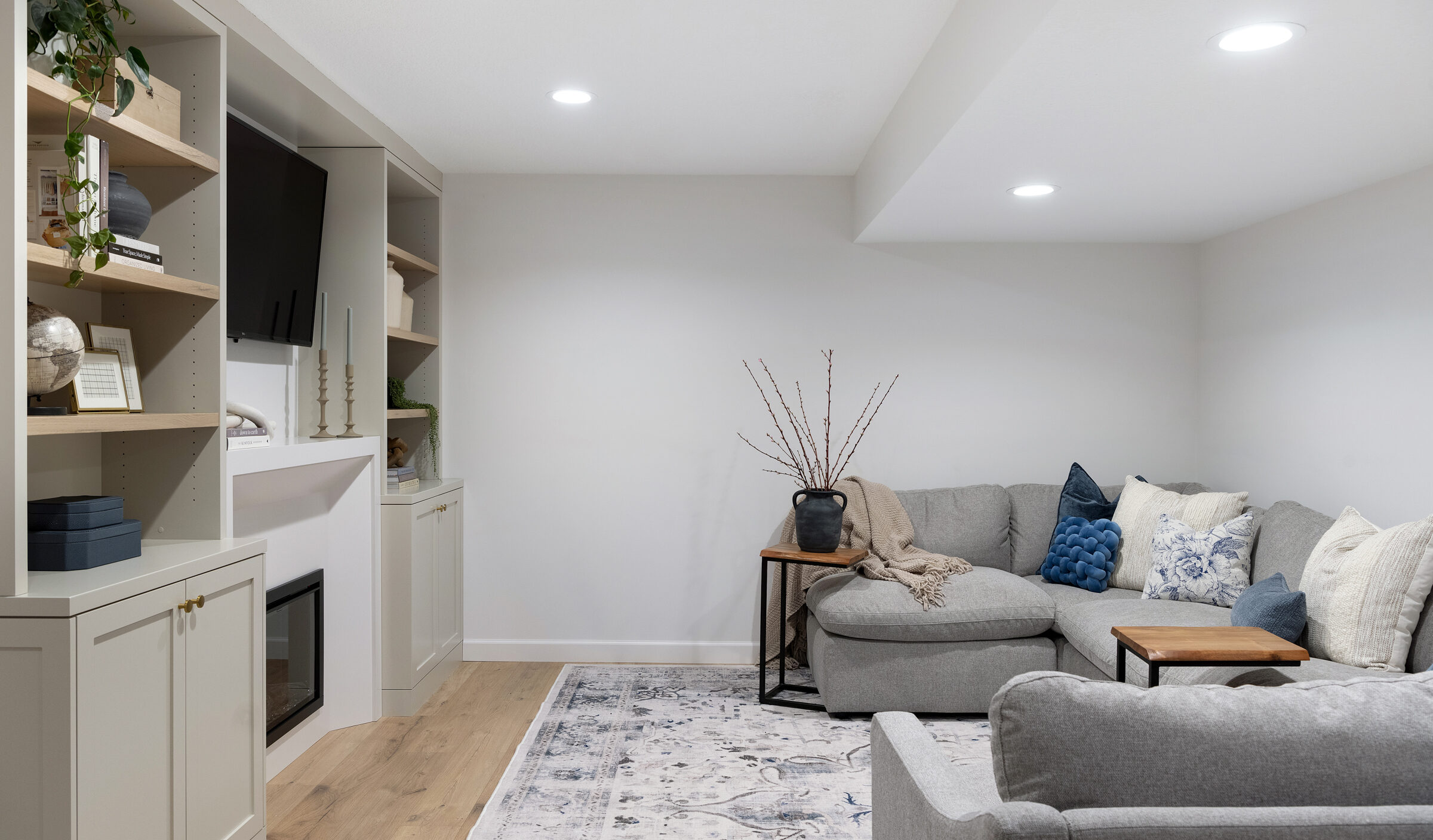 a photo of an Entertainment wall on the left and a comfy sectional on the right | construction2style
