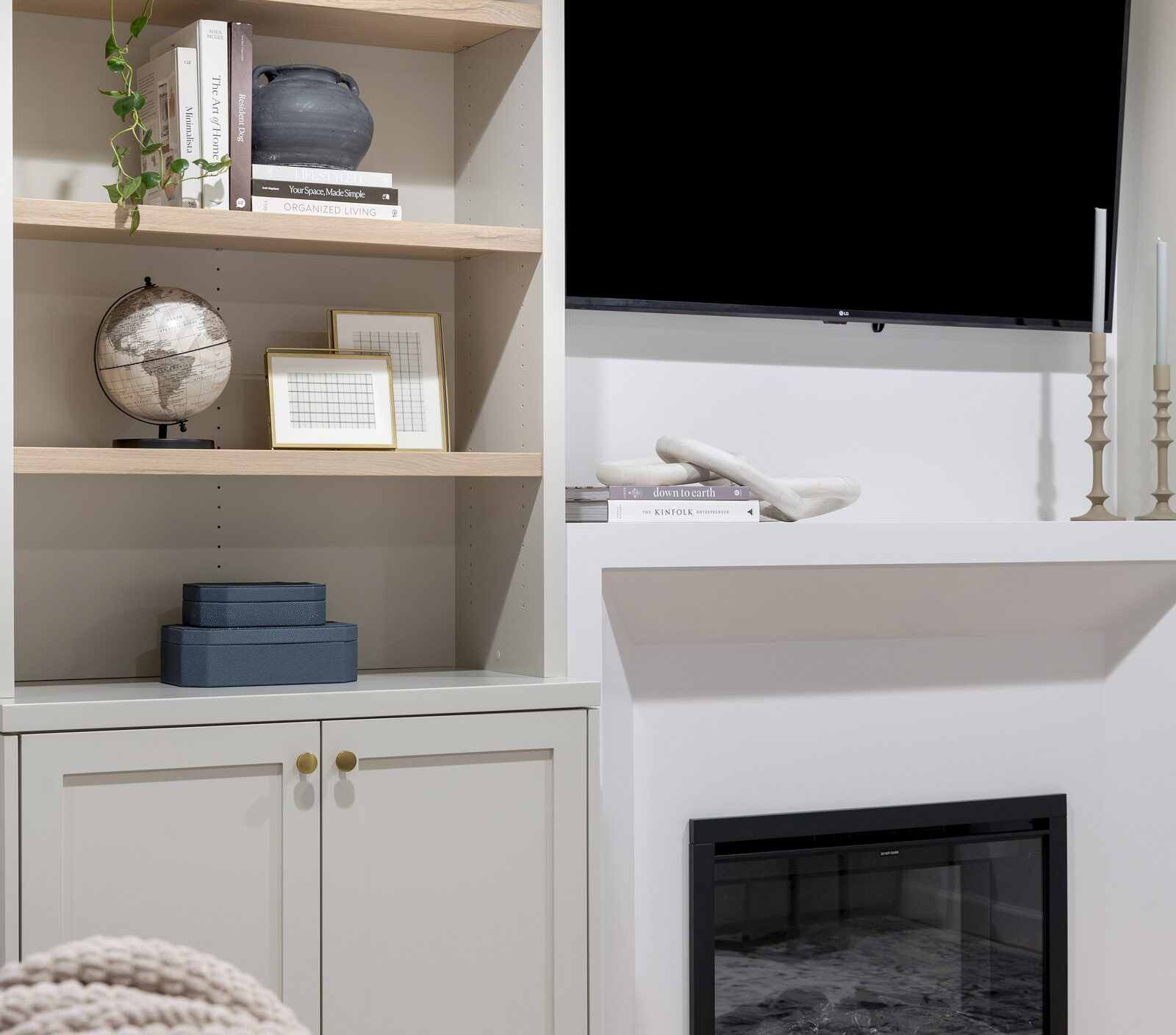 a beautiful photo of an Entertainment wall that Includes base cabinetry with a custom fireplace surround, frameless upper cabinetry down to the countertop with rift sawn white oak adjustable shelves and finished interior | construction2style